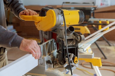 cutting-moulding-renovation-new-house-construction-finishing-work-worker-cuts-molding.jpg